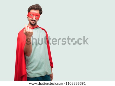crazy man as a super hero smiling with a proud, satisfied and happy look, making a gesture as if accepting a challenge, confident of success.