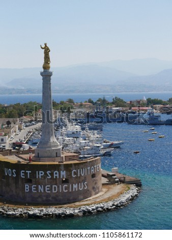 Madonna of the Letter Statue over Messina harbor, Sicily, Italy, with Italian Navy and Coast Guard boats in the background.