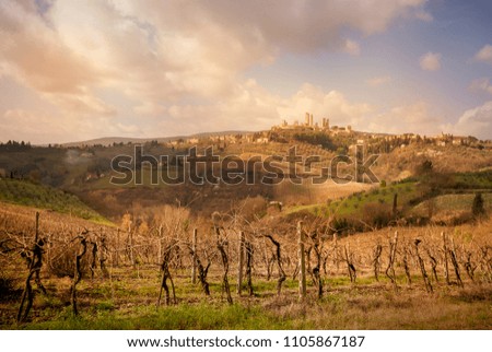 San Gimignano medieval town towers skyline and countryside landscape panorama at sunset. Tuscany, Italy, Europe.