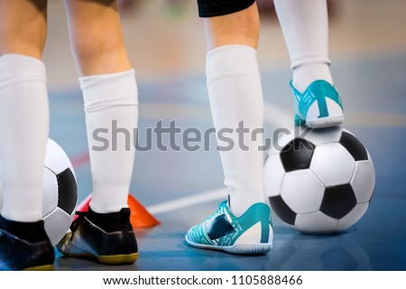 Indoor soccer players training with balls. Indoor soccer sports hall. Football futsal player, ball, futsal floor. Sports background. Futsal league. Indoor football players with classic soccer ball. Royalty-Free Stock Photo #1105888466