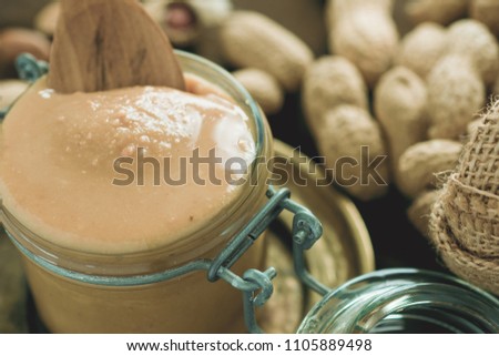 Peanut Butter in Glass Jar as Healthy Breakfast. Vegetarian Food Concept.
