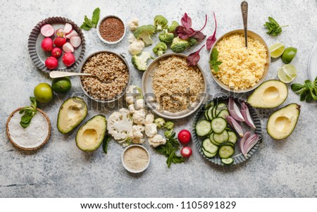 Nutrient rich foods cooked quinoa amaranth pearl barley dish on table with variety vegetables herbs seeds nutrient rich balanced food concept Royalty-Free Stock Photo #1105891829