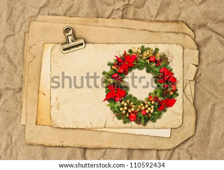 old blank paper and photo sheets with clip and christmas wreath picture. nostalgic background