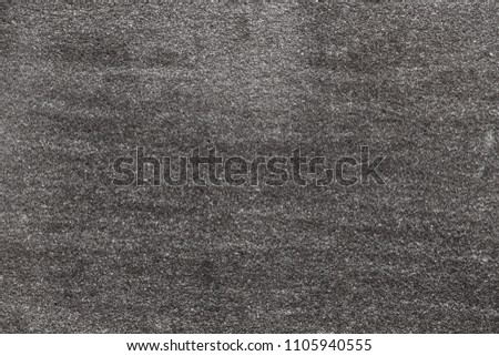 Asphalt with fine grain texture. Close-up of road background in black and white color. Top view of the rough surface