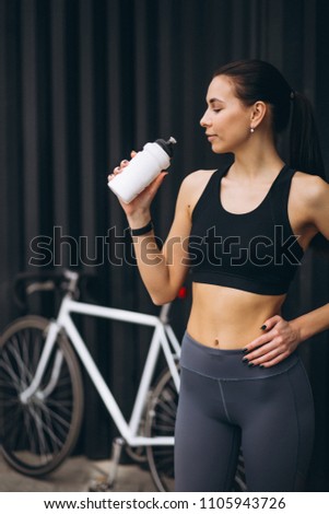 Woman drinking water biking