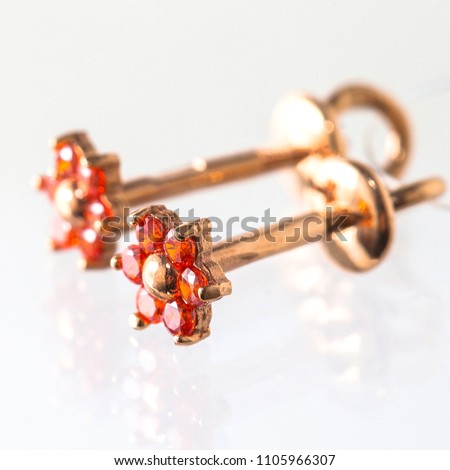 gold earrings on a white background