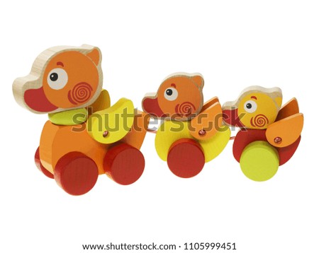 A colorful duck toys made of wood on a white background