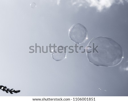 Grey picture of a flying soap bubbles.