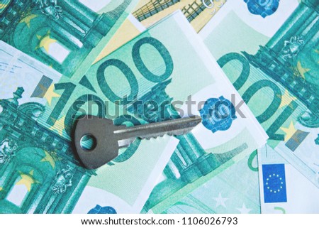 Keys on background of money. Concept of buying or renting home.
