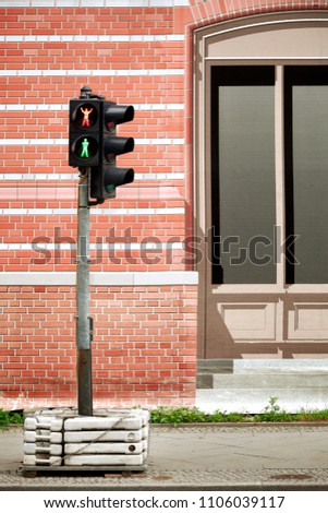 Humorous red and green traffic lights concept. Provisional traffic light against fictitious street canvas.