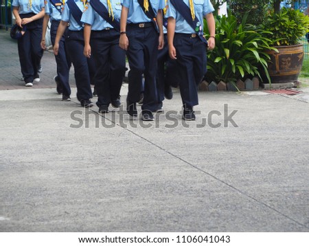 Students in navy blue pants and light blue pathfinder uniform were having marching activity 