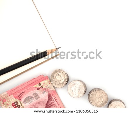 Thai banknotes and coins with to pay isolated on white background with book and pencil for plan save money
