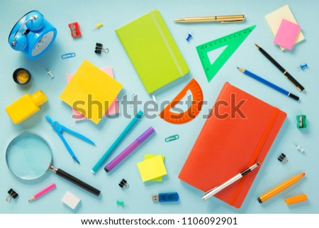 notebook and school accessories at abstract background surface