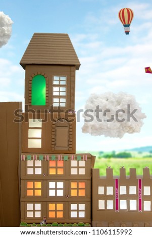Photo of a brown recycled paper create the building ,cloud , kite, hot air balloon