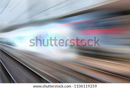 White high speed train runs on rail tracks . Train in motion.