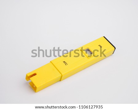 Electronic pH meter on white background.