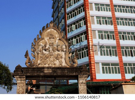 Detail of an ancient temple and a colorful townhouse in downtown of Phnom Penh, the capital of Cambodia, Asia. 