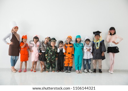 group of childrens dressed in costumes of different professions on white background together