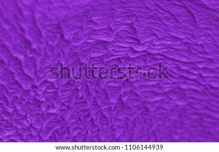 Abstract background of a wrinkled pelican beak skin toning in the color of the year Pantone ultra violet. Close up.