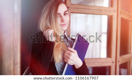 Young pretty blonde girl student before class

