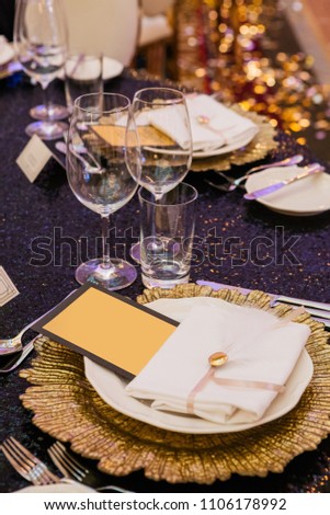 decorations for a holiday in a restaurant with flowers and glasses,cards, inscription, invitation