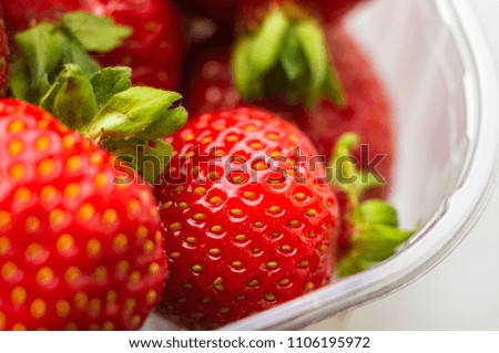 fresh ripe strawberries on black ceramic plate