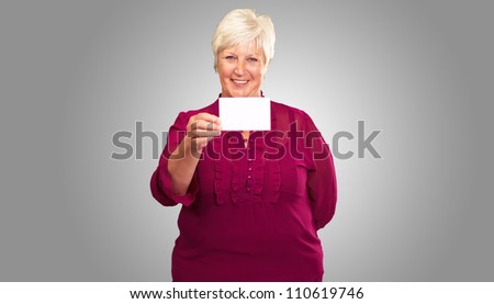 Old Woman Showing  Paper On Gray Background