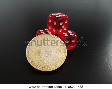 Glowing Bitcoin BTC coin on a stack of red dices showing sixes. This gambling concept is isolated on a black background.
