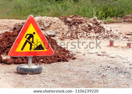 Road works sign for construction works, pavement construction. Traffic, warning sign road repairing, road maintenance. Red, black, yellow triangle road sign work. Reconstruction and infrastructure.