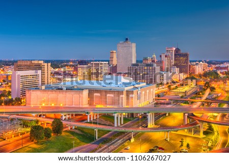 Memphis, Tennessee, USA downtown city skyline over highways at dusk.