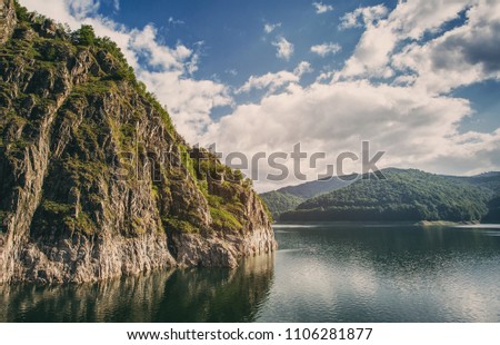 Mountain lake. Scenic landscape. Artistic picture. High mountain peaks. Beauty world. Eastern Europe. Romania.Lake vidraru. Beautiful blue sky with clouds