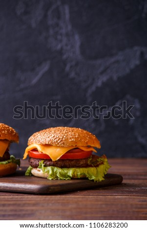 Image of two hamburgers on wooden table
