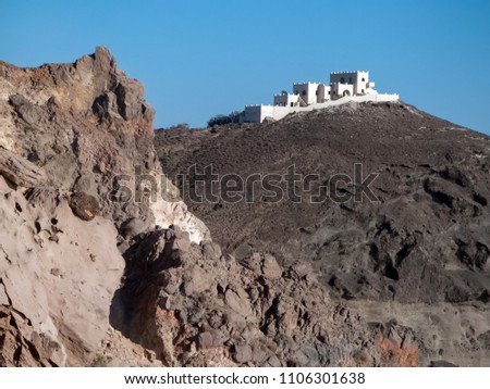 White villa, Building on the rock, clear blue sky background. Picturesque view of Santorin, Greece, Europe. Traveling concept background. Cycladic island. 