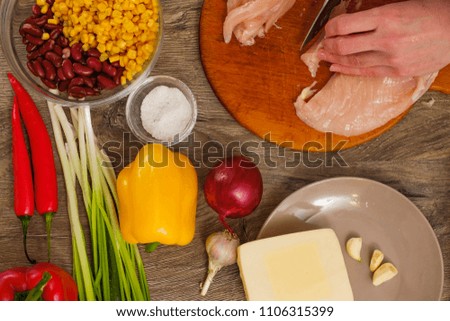 Ingredients for Burritos wraps chicken meat, corn, tomatoes and peppers on wooden background. Top view