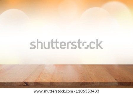 Empty desk with blurred light orange gradient bokeh abstract background.