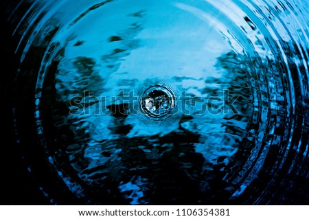 Top view Closeup blue water rings, Circle reflections in pool. Royalty-Free Stock Photo #1106354381