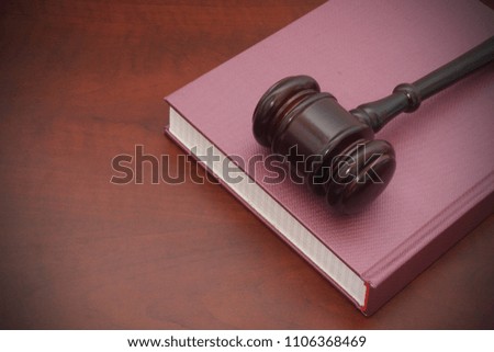 Wooden jgavel on legal book on  table, law and justice concept