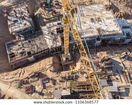 flying drone over construction site at sunny morning