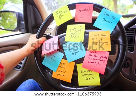 Steering wheel covered in notes as a reminder of errands to do Royalty-Free Stock Photo #1106375993