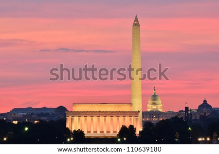 Washington DC city view at a reddish sunrise, including Lincoln Memorial, Monument and Capitol building