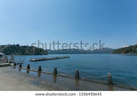 Natural background concept . Lake  , pier  and mountain view in Asia  . Beautiful blue color lake and sky .