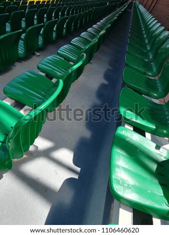Green seats on the stadium podium.