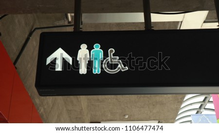 lady, gentleman and people on wheelchair toilet sign with arrow