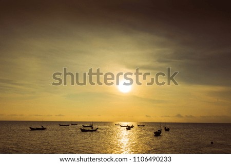 Sunset at the sea and boat at Chao Lao Beach, Chanthaburi Province, Thailand.
