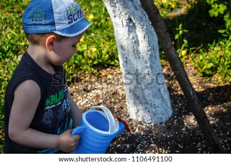 boy and watering can play outdoor