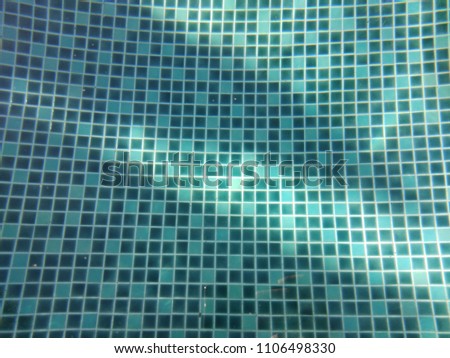 Swimming pool deep blue water, natural abstract background with sunlight.