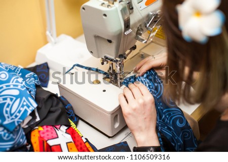 close up Tailoring Process - Women's hands behind her sewing