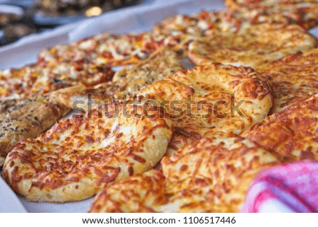Ready pizza with meat and sausage background with vegetables. Summer holidays and food in nature. Stock Photo