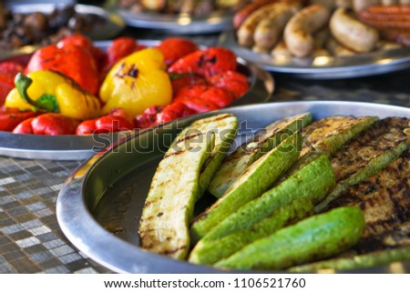 Fried vegetables on the grill with a delicious crust on the background of vegetables. Summer holidays and food in nature. Stock Photo
