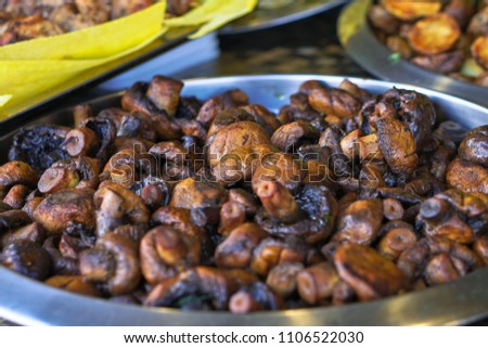 Fried vegetables mushrooms on the grill with a delicious crust on the background of vegetables. Summer holidays and food in nature. Stock Photo